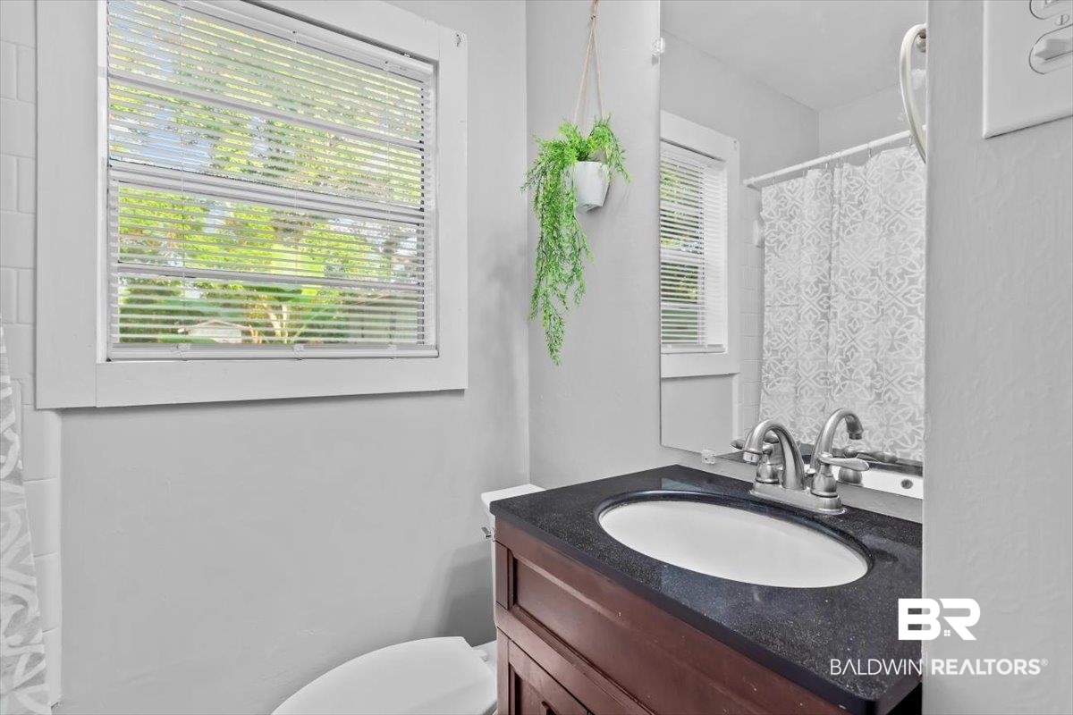 4918 Quimby Drive Mobile, AL 36619 - Photo 14 of 38 Bathroom featuring vanity, toilet, and a shower with curtain