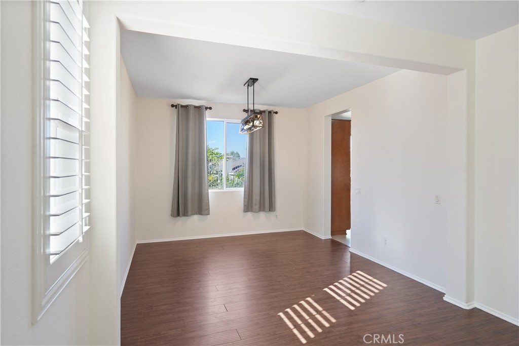38815 Cobblestone Circle Murrieta, CA 92563 - Photo 18 of 49 a view of an empty room with a window and wooden floor
