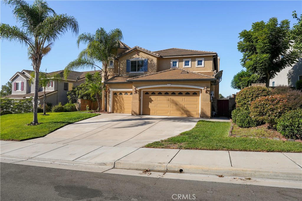 38815 Cobblestone Circle Murrieta, CA 92563 - Photo 2 of 49 front view of house with a yard and palm trees