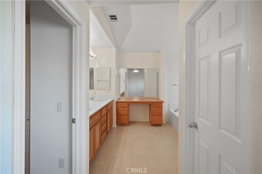 38815 Cobblestone Circle Murrieta, CA 92563 - Photo 26 of 49 a large bathroom with a granite countertop double vanity sink a mirror and a bathtub
