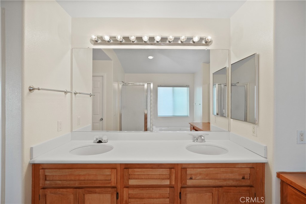38815 Cobblestone Circle Murrieta, CA 92563 - Photo 28 of 49 a bathroom with a sink vanity and a mirror