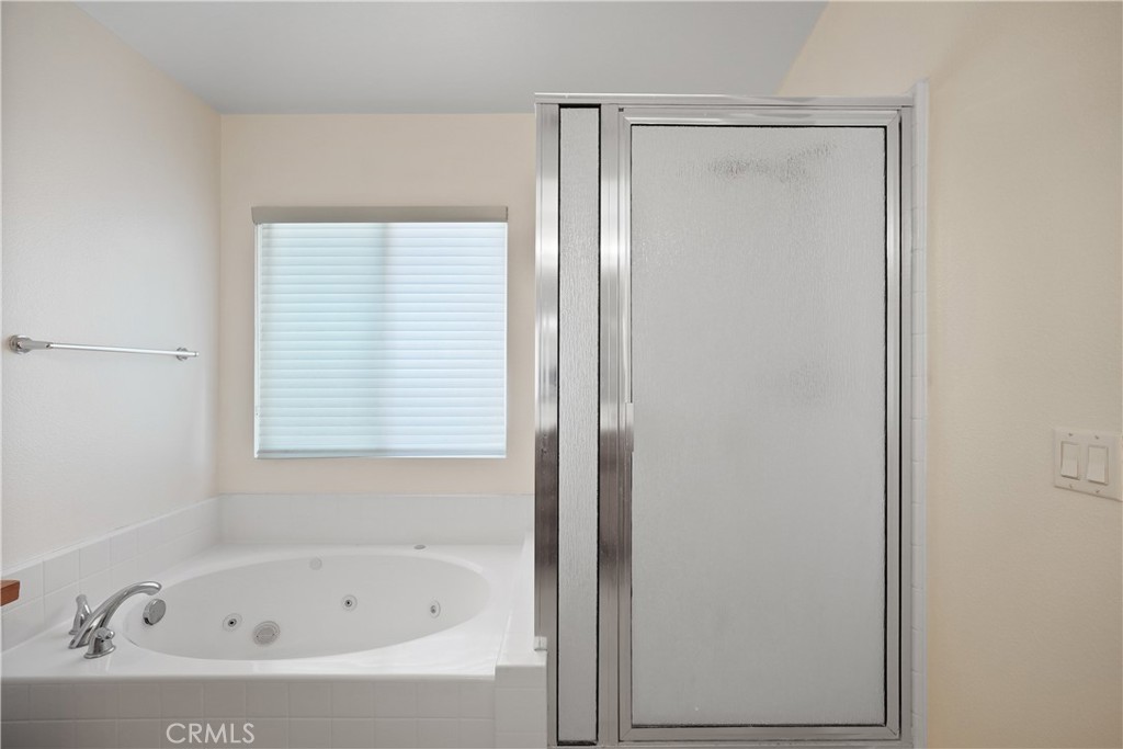 38815 Cobblestone Circle Murrieta, CA 92563 - Photo 29 of 49 a white bath tub sitting next to a window
