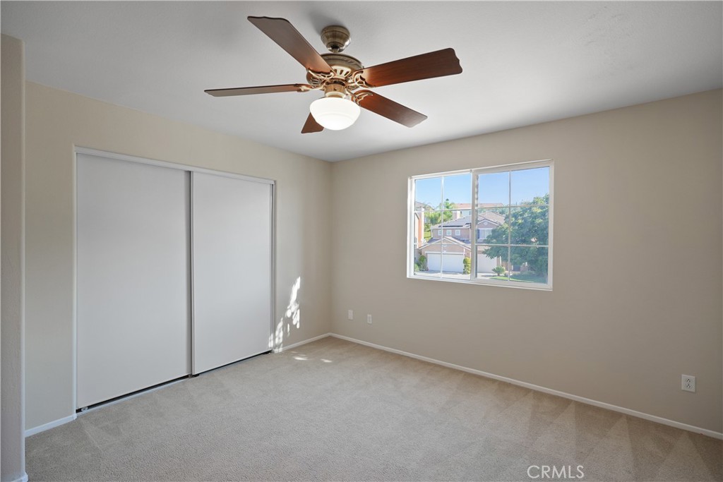 38815 Cobblestone Circle Murrieta, CA 92563 - Photo 36 of 49 an empty room with window and ceiling fan