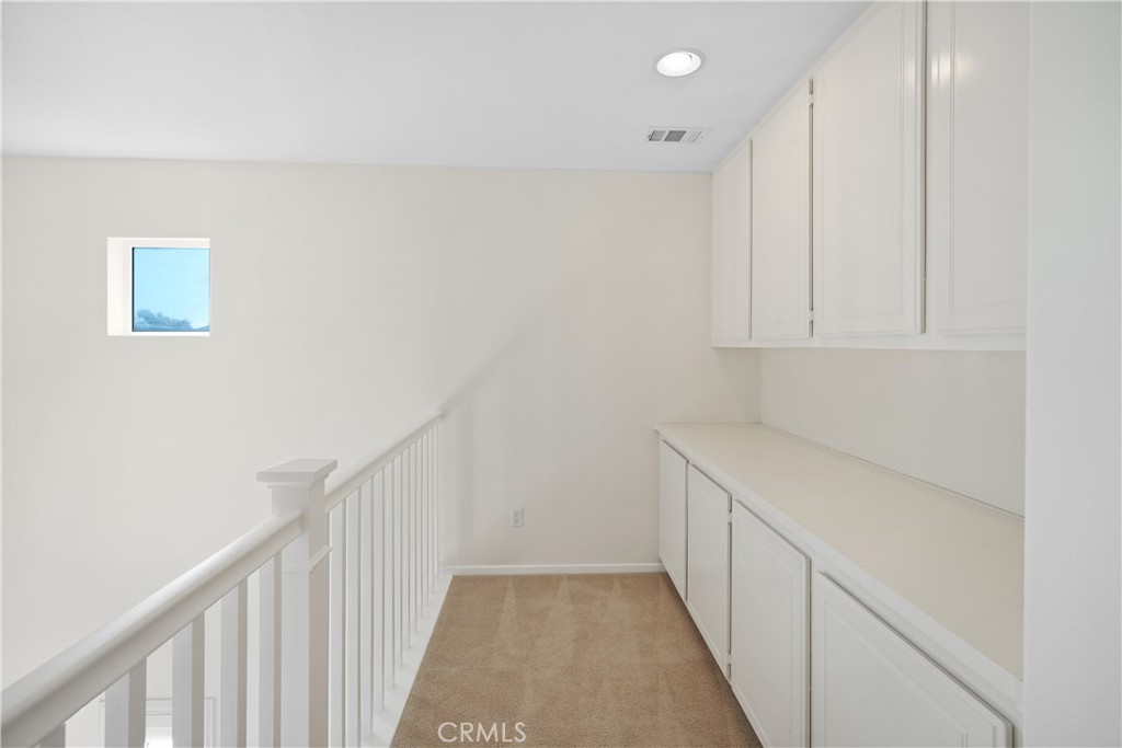 38815 Cobblestone Circle Murrieta, CA 92563 - Photo 48 of 49 a view of a hallway to an empty room with wooden floor