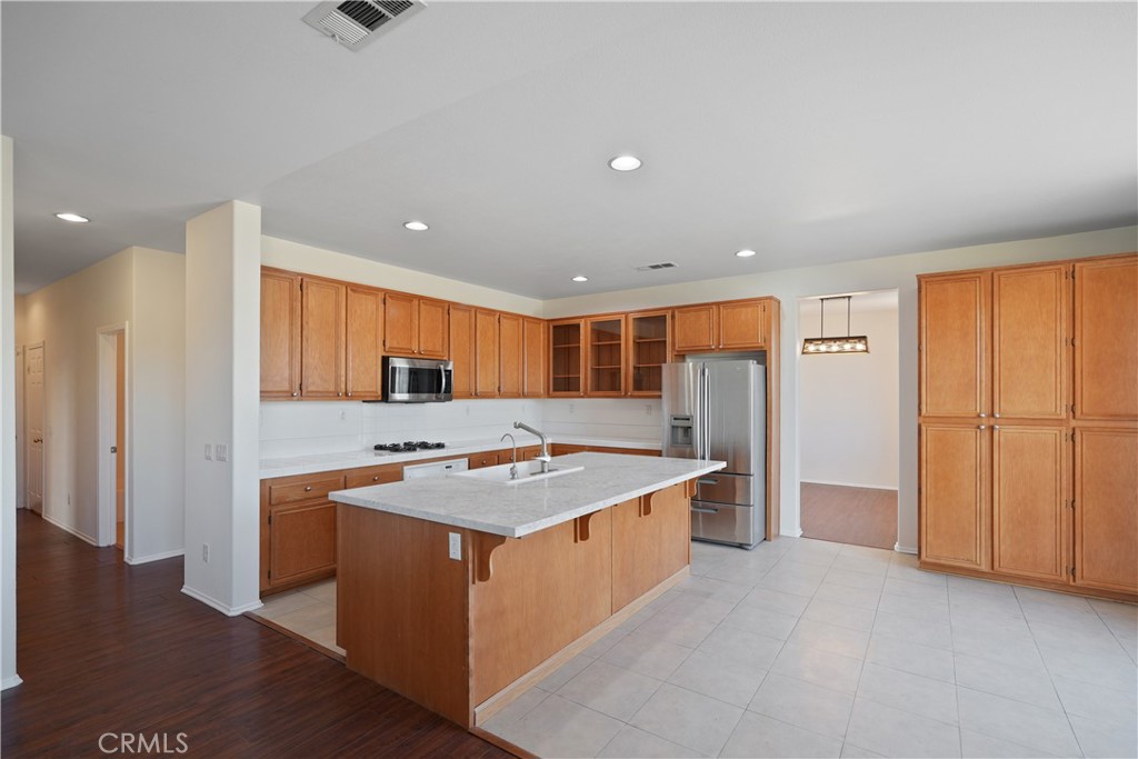 38815 Cobblestone Circle Murrieta, CA 92563 - Photo 5 of 49 a kitchen with a sink stove and refrigerator
