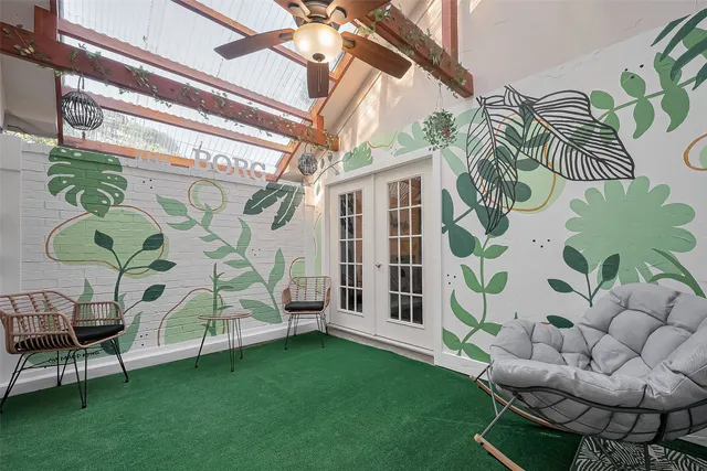 a living room with furniture and a floor to ceiling window