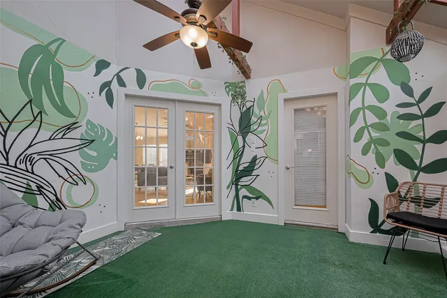 a view of a livingroom with furniture and a floor to ceiling window
