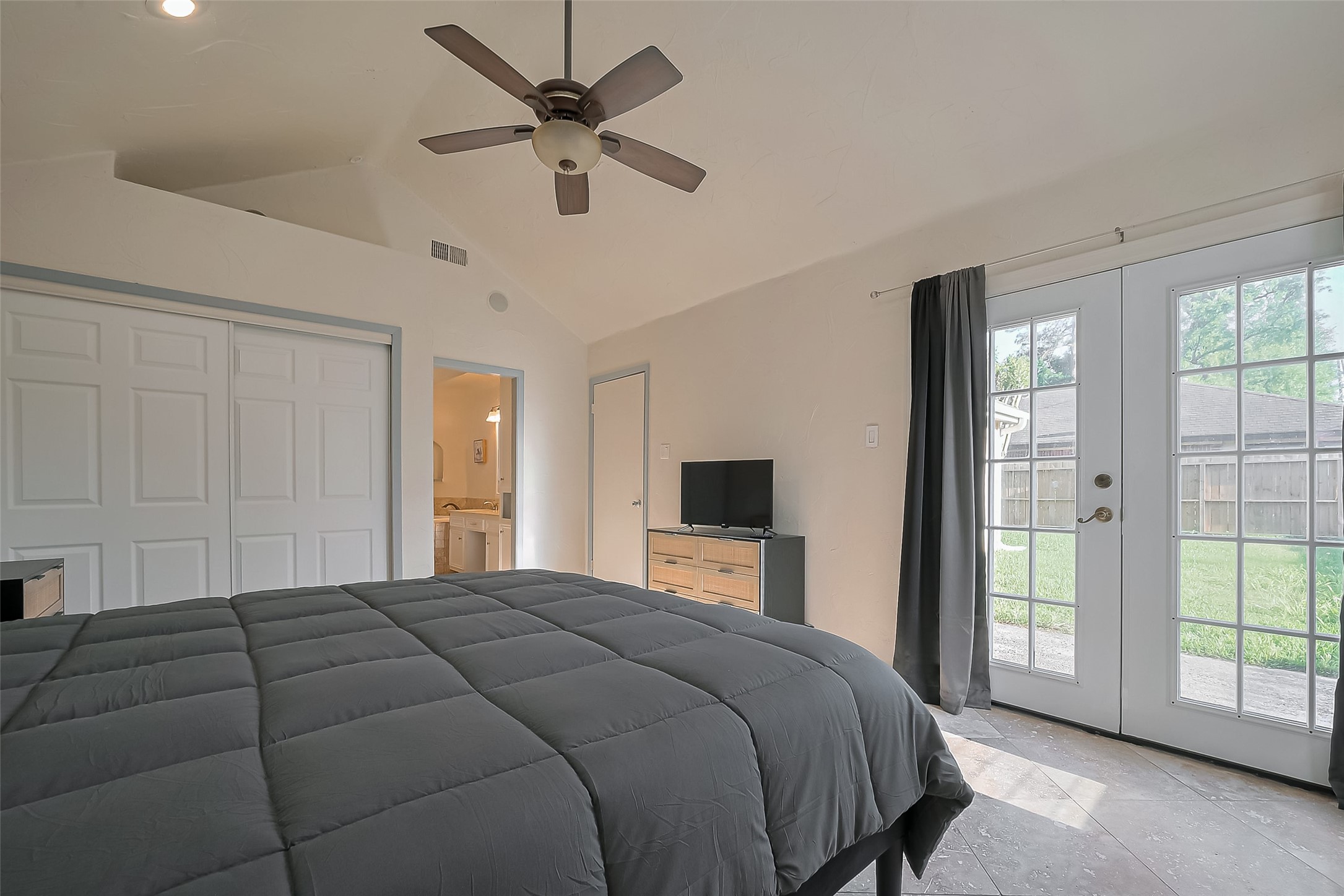 30411 Arborg Drive Spring, TX 77386 - Photo 16 of 30 a bedroom with a large bed and a tv