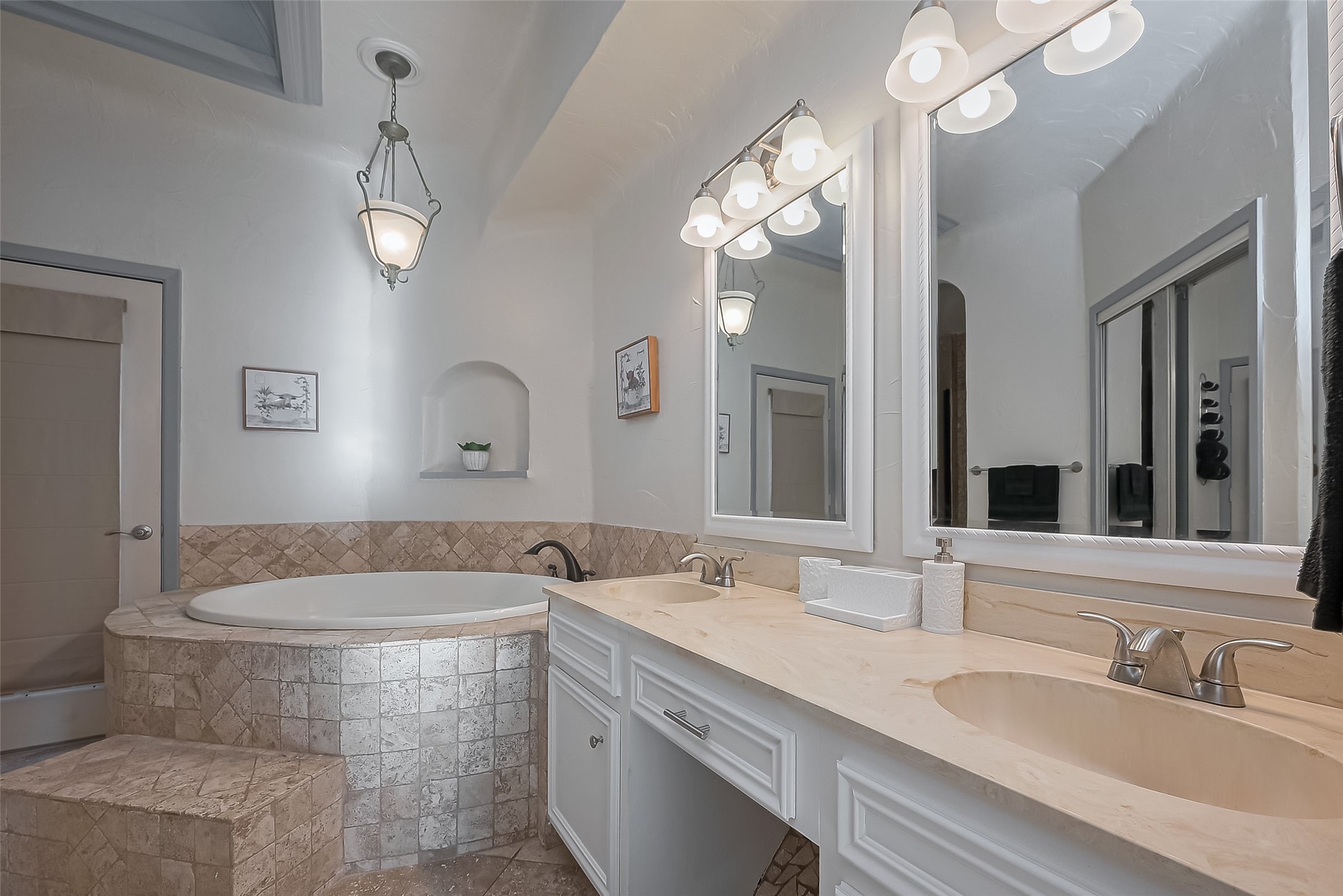 30411 Arborg Drive Spring, TX 77386 - Photo 18 of 30 a bathroom with a tub a double vanity sink and a mirror