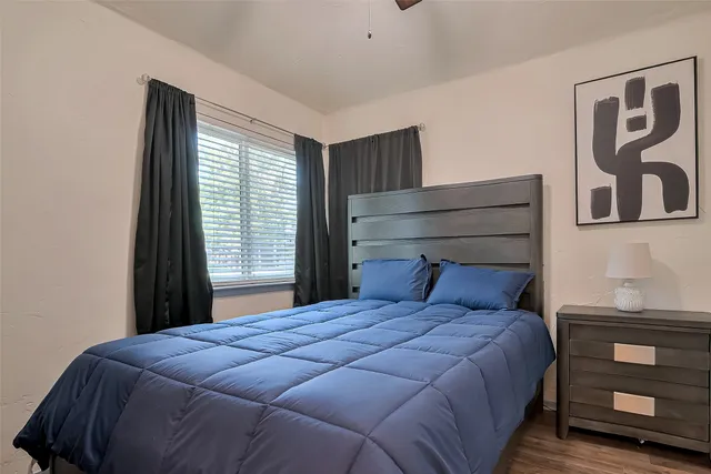 a bedroom with a large bed and a window