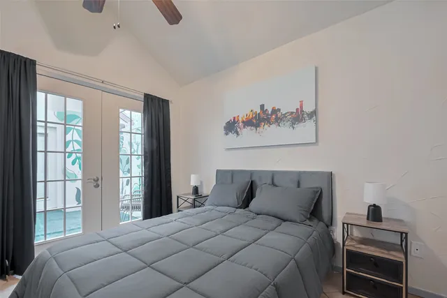 a bedroom with a bed and a large window