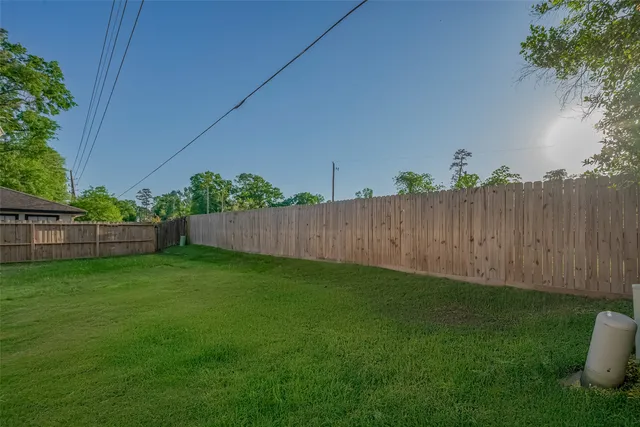 a view of a backyard with wooden fence