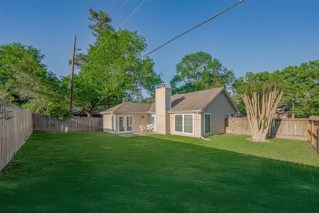 a front view of a house with a yard and trees