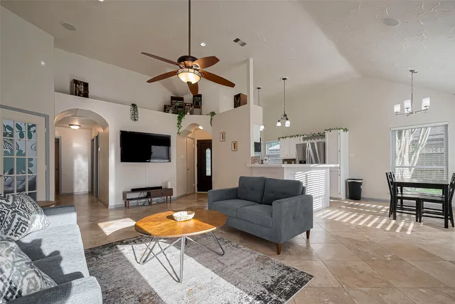 a living room with furniture a dining table and a fireplace