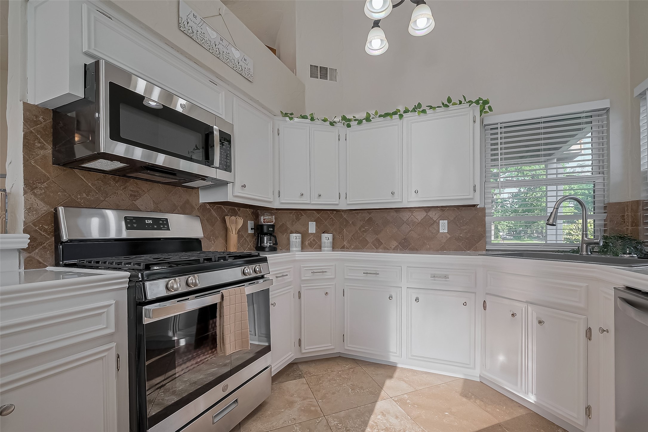 30411 Arborg Drive Spring, TX 77386 - Photo 6 of 30 a kitchen with stainless steel appliances white cabinets and a stove top oven