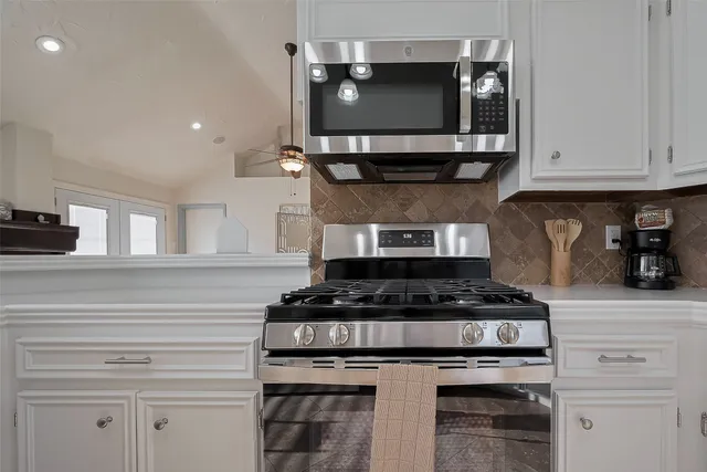 a kitchen with stainless steel appliances granite countertop a stove and a microwave