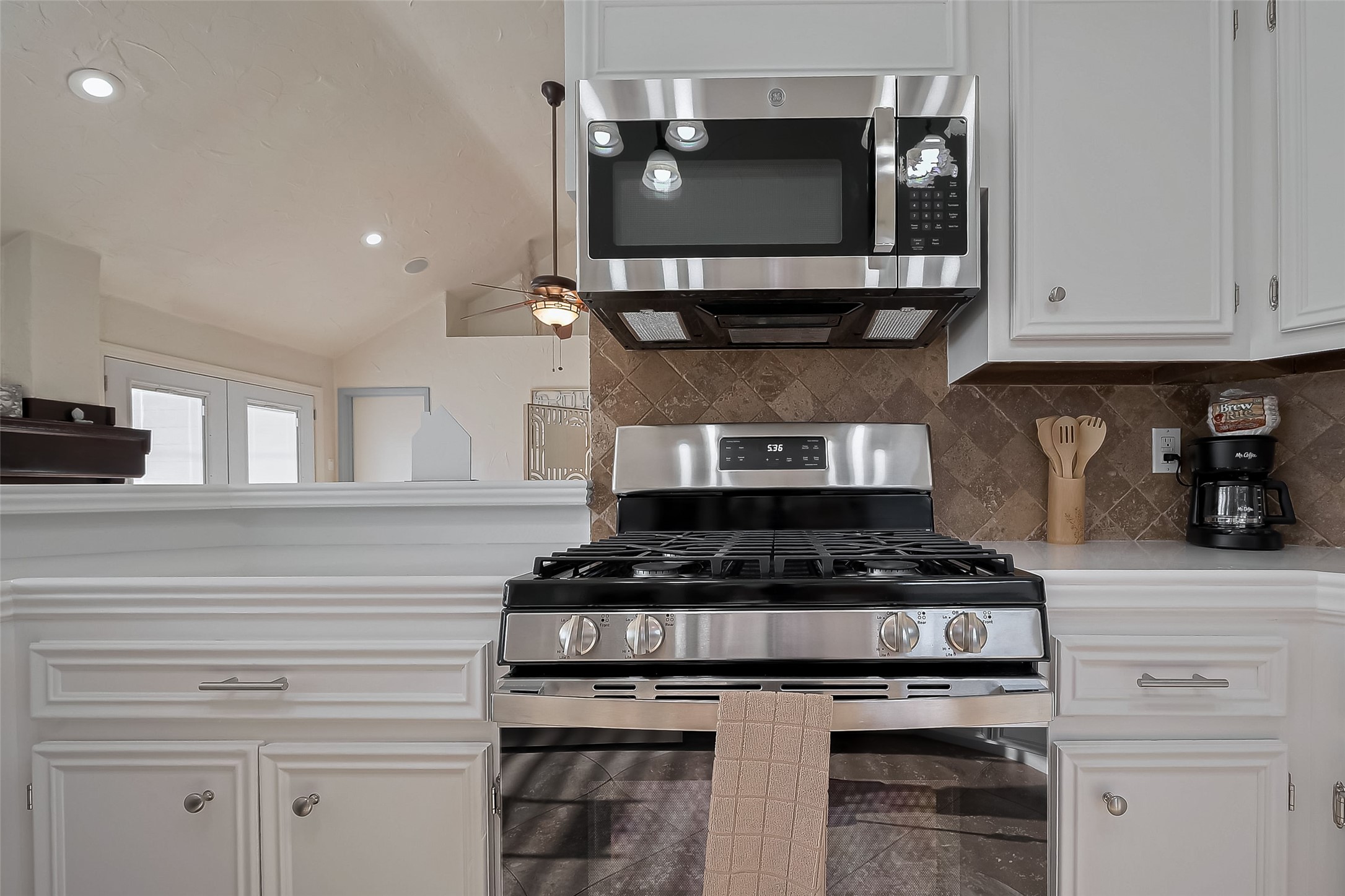 30411 Arborg Drive Spring, TX 77386 - Photo 7 of 30 a kitchen with stainless steel appliances granite countertop a stove and a microwave