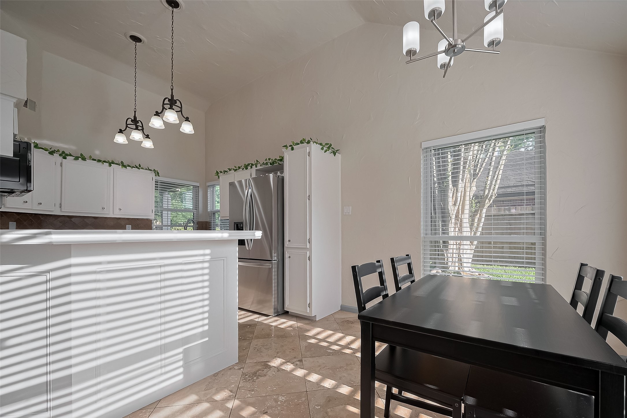 30411 Arborg Drive Spring, TX 77386 - Photo 9 of 30 a view of a dining room with furniture and a chandelier