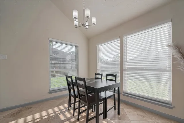 a view of a dining room with furniture and window