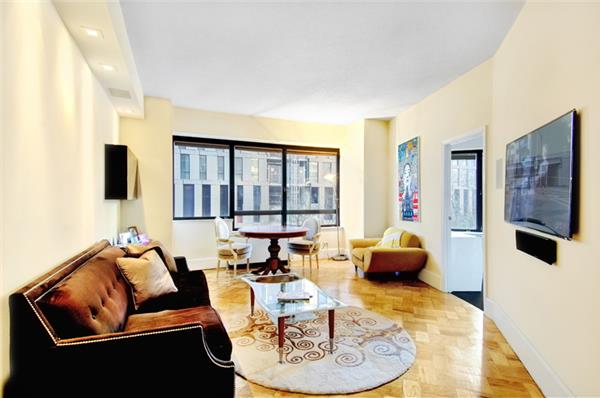630 1st Avenue, Unit 4E Manhattan, NY 10016 - Photo 1 of 1 a living room with furniture and a floor to ceiling window