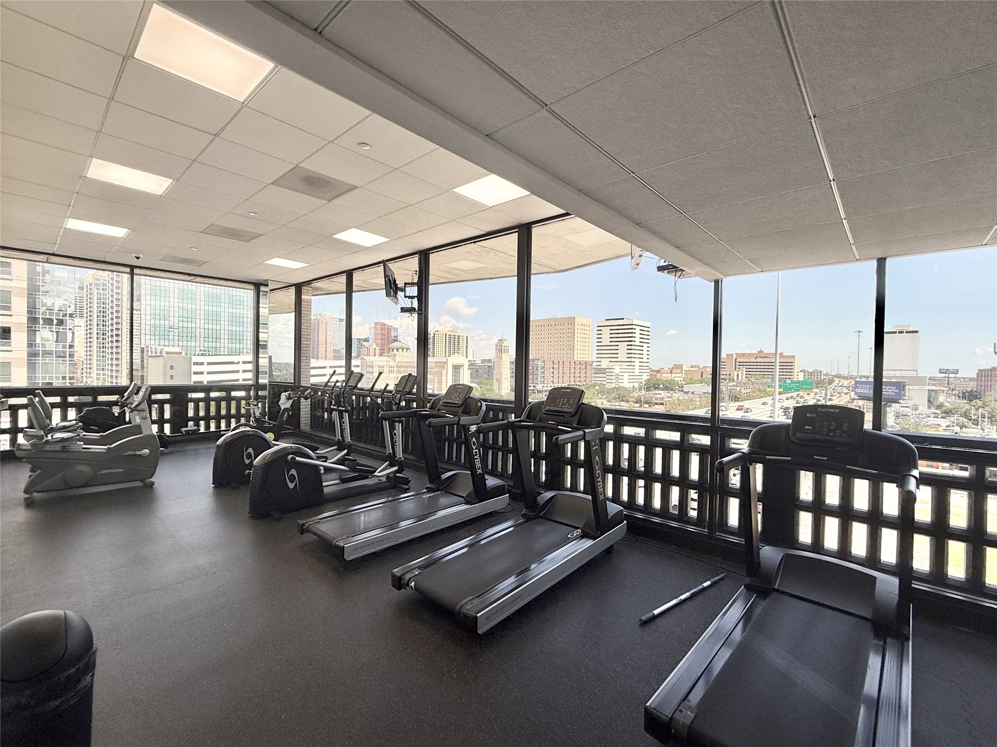2016 Main Street, Unit 1022 Houston, TX 77002 - Photo 37 of 48 a view of a room with gym equipment and floor to ceiling window