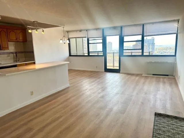wooden floor in an empty room with a window