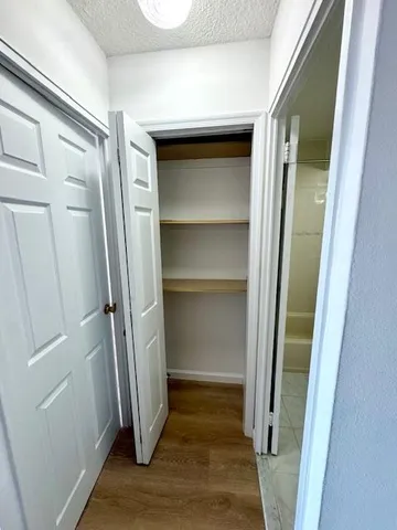 a view of walk in closet with empty racks