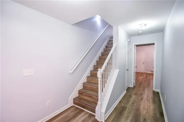a view of an empty room with a fireplace and a window