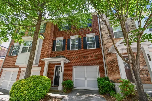 a view of a hallway with wooden floor and entryway