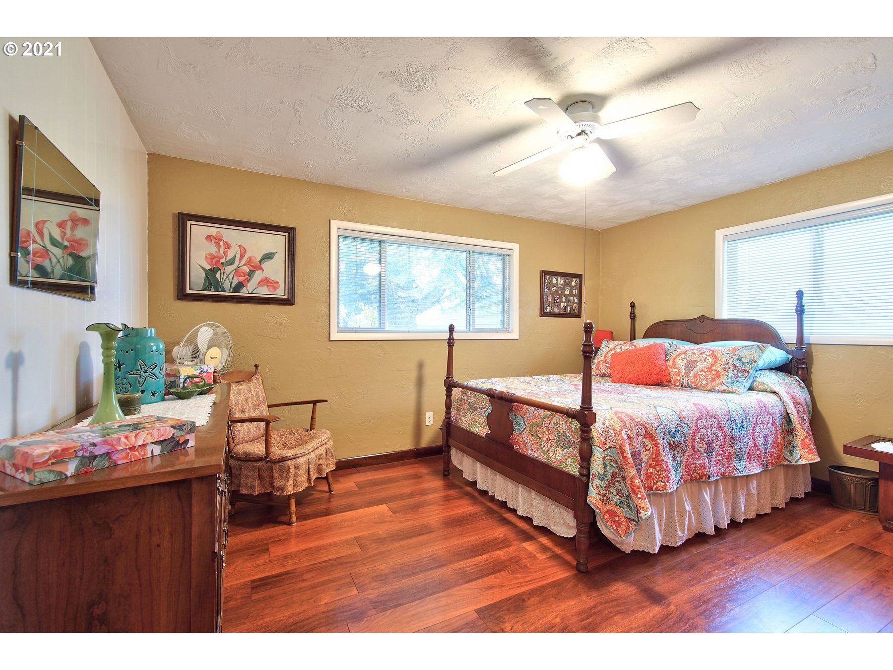 29223 South Meridian Road Hubbard, OR 97032 - Photo 23 of 32 a bedroom with a bed a chandelier and a window