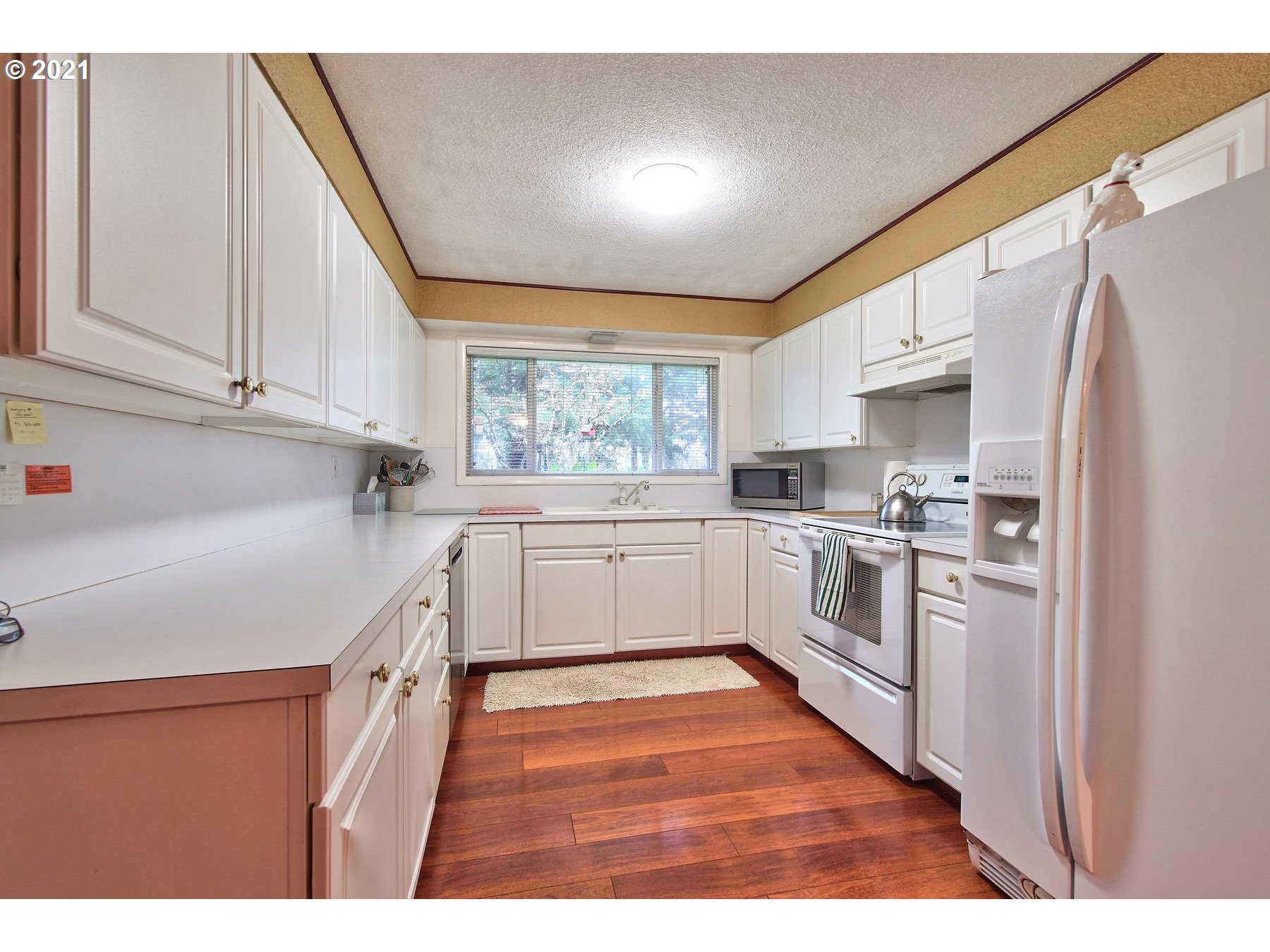 29223 South Meridian Road Hubbard, OR 97032 - Photo 10 of 32 a kitchen with white cabinets and white appliances