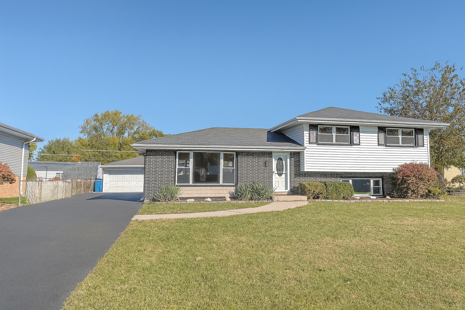 a front view of house with yard outdoor seating and barbeque oven
