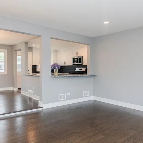 a view of kitchen with microwave and cabinets