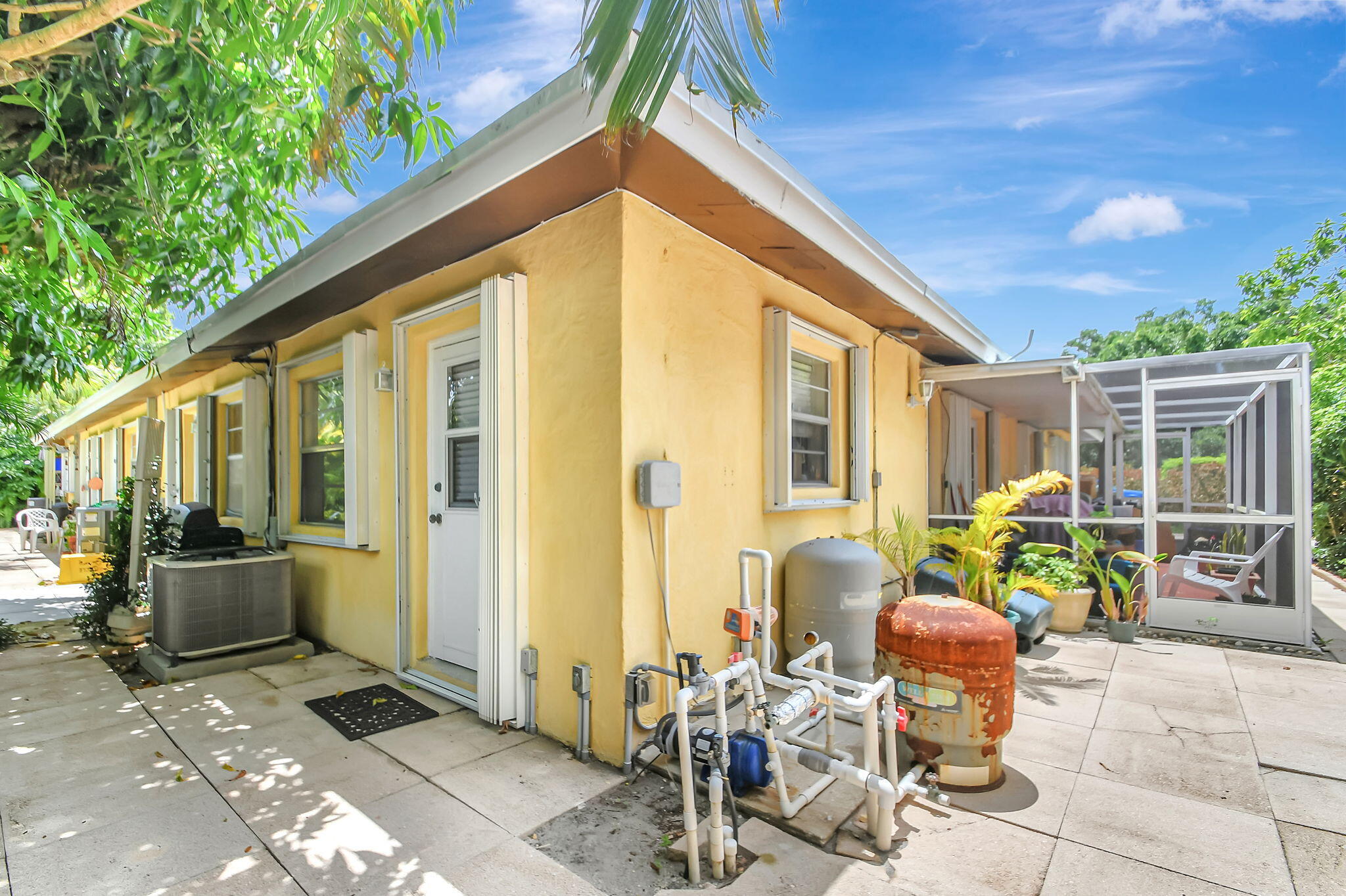 1853 Service Road North Palm Beach, FL 33408 - Photo 109 of 113 a backyard of a house with outdoor seating