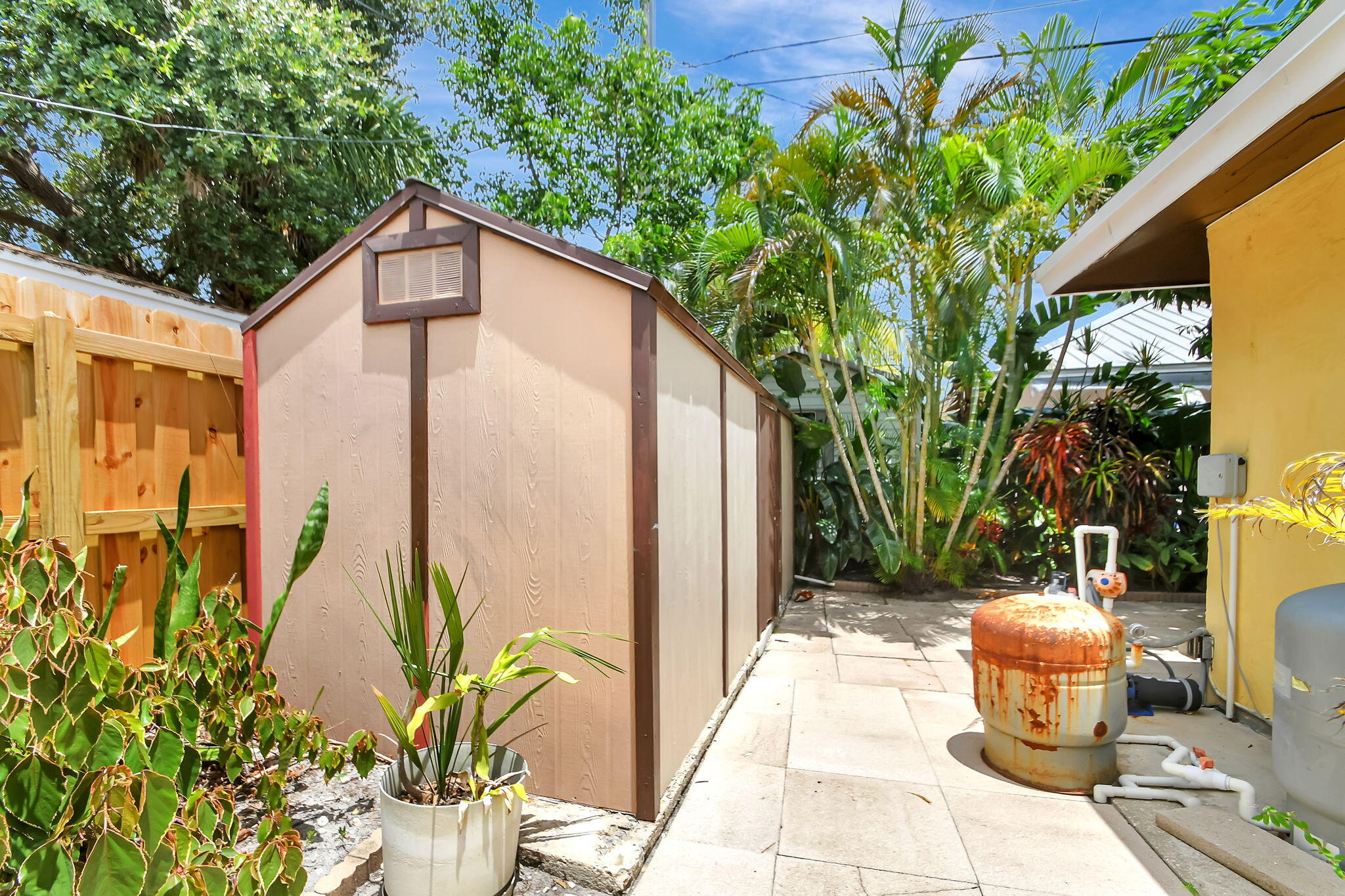 1853 Service Road North Palm Beach, FL 33408 - Photo 110 of 113 a backyard of a house with fountain plants and large tree