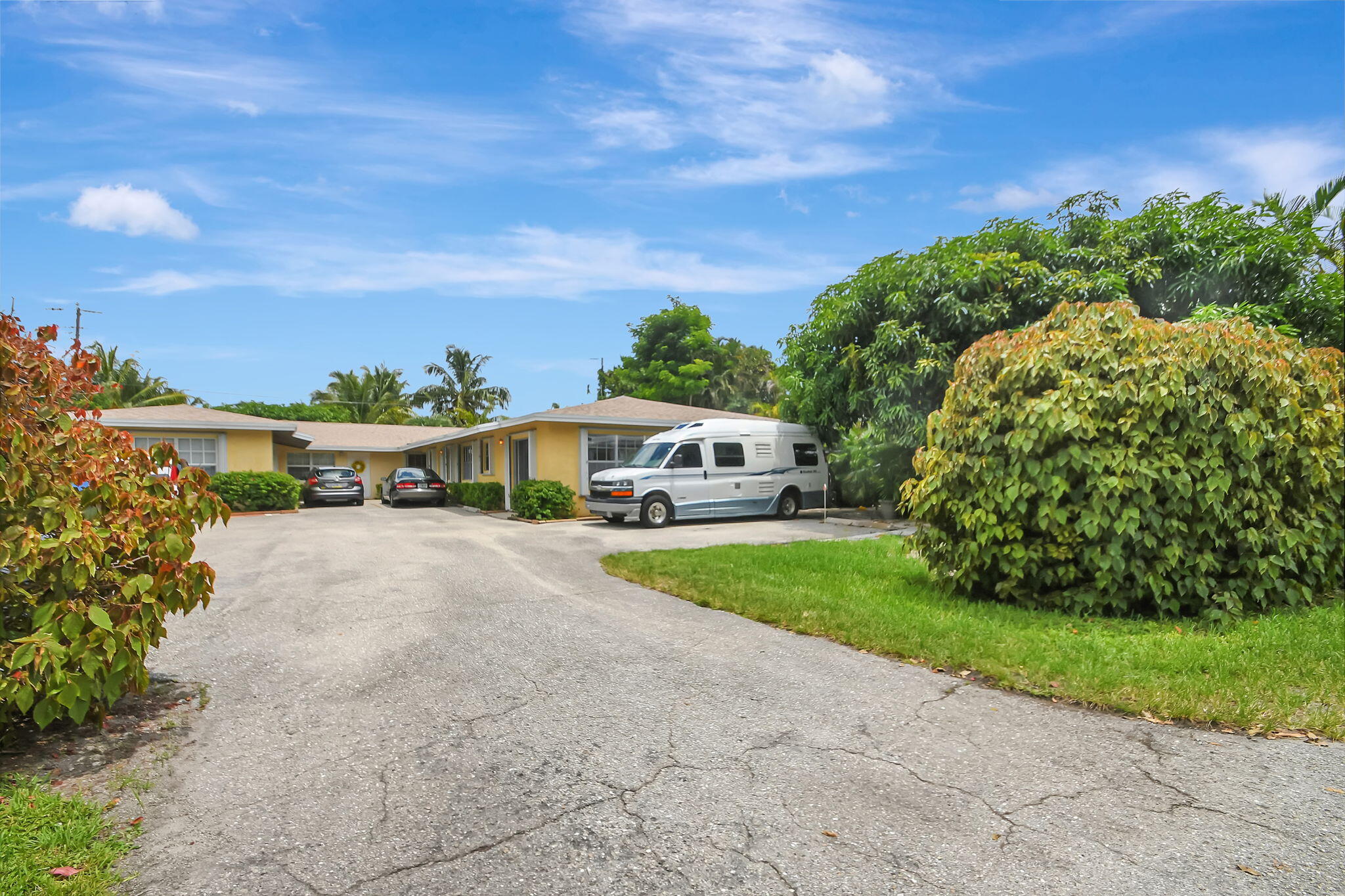 1853 Service Road North Palm Beach, FL 33408 - Photo 113 of 113 a front view of a house with a yard and potted plants