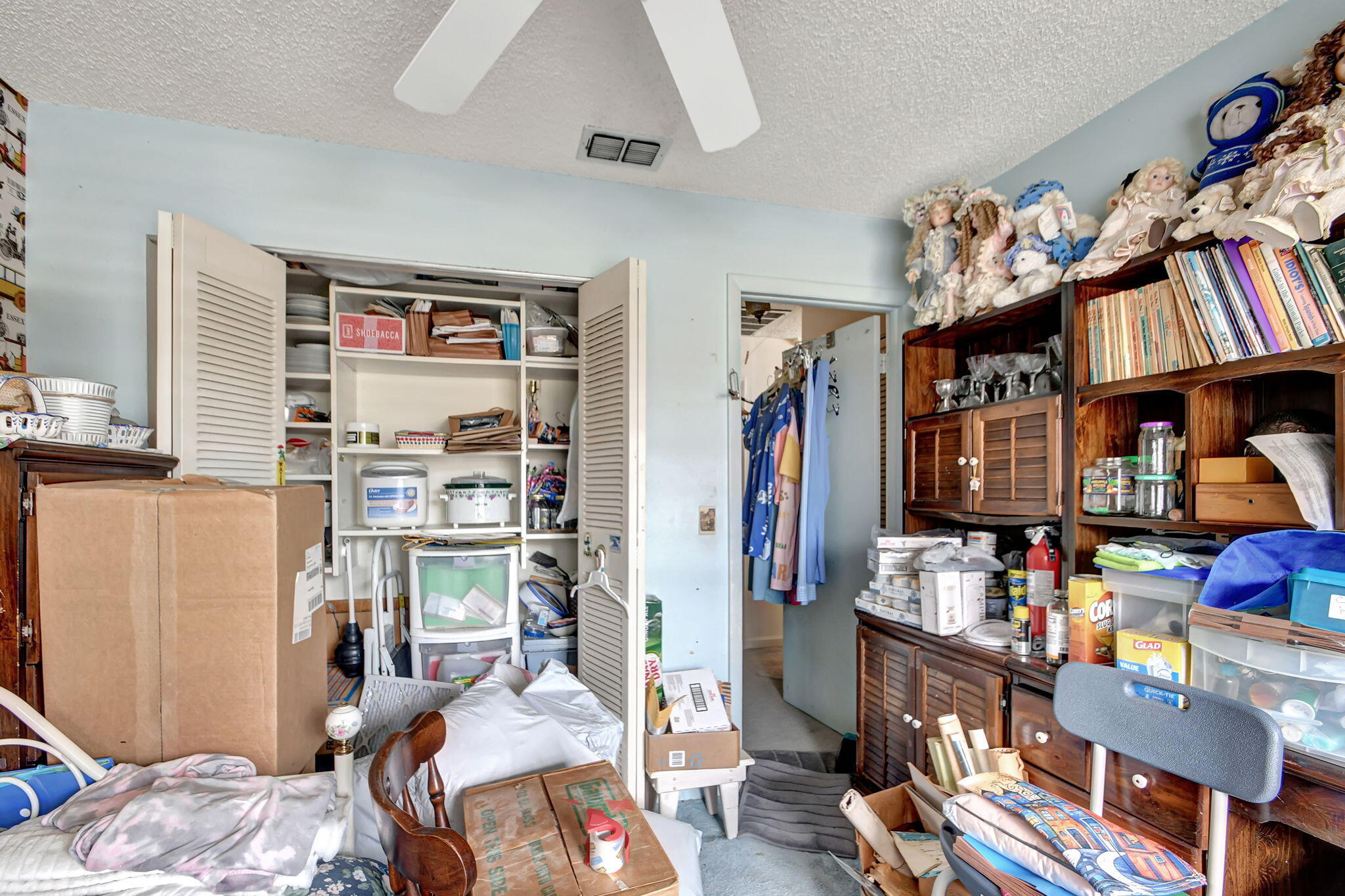 1853 Service Road North Palm Beach, FL 33408 - Photo 13 of 113 a bedroom with furniture and a book shelf