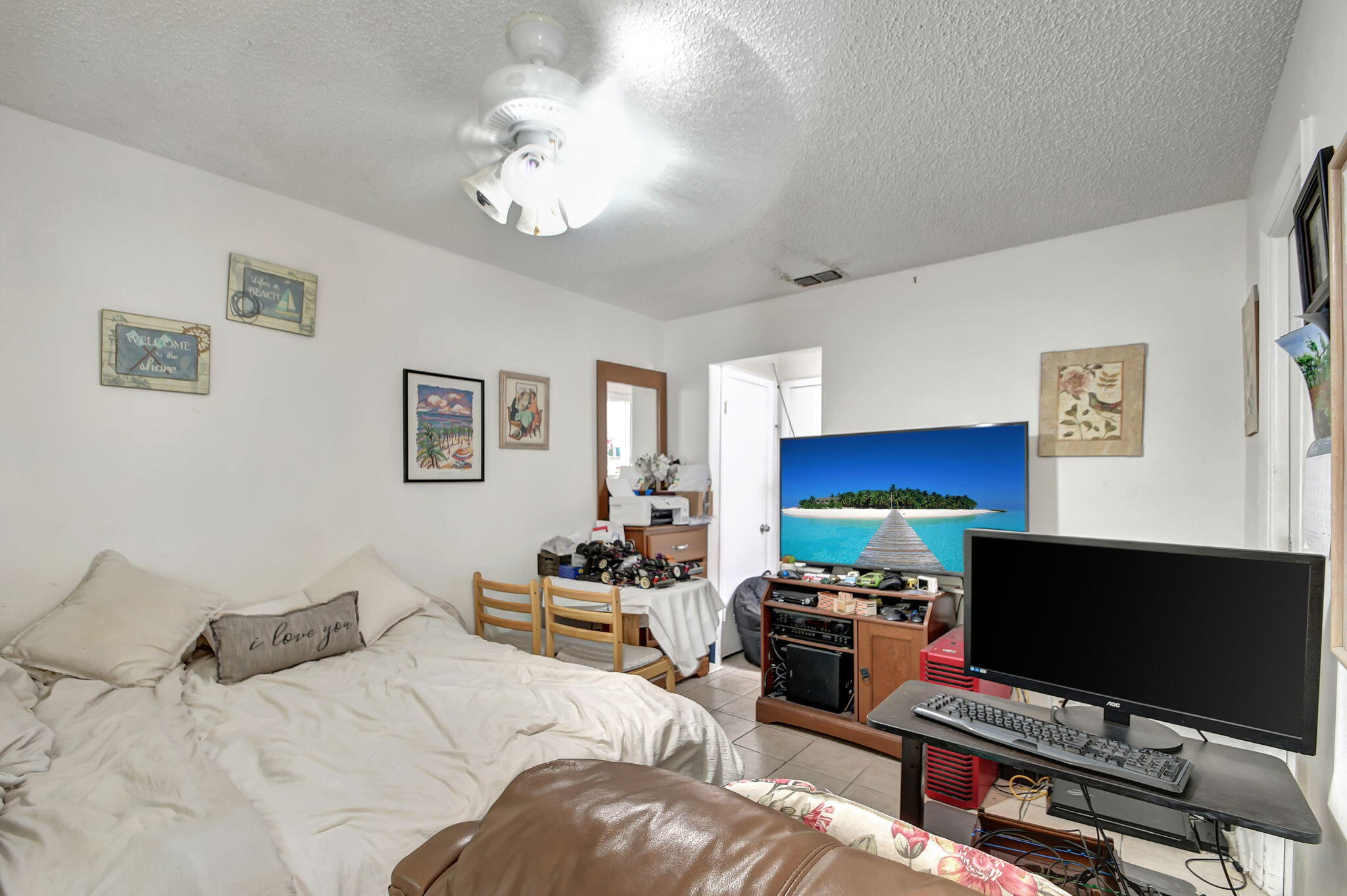 1853 Service Road North Palm Beach, FL 33408 - Photo 21 of 113 a bedroom with a bed and a flat screen tv