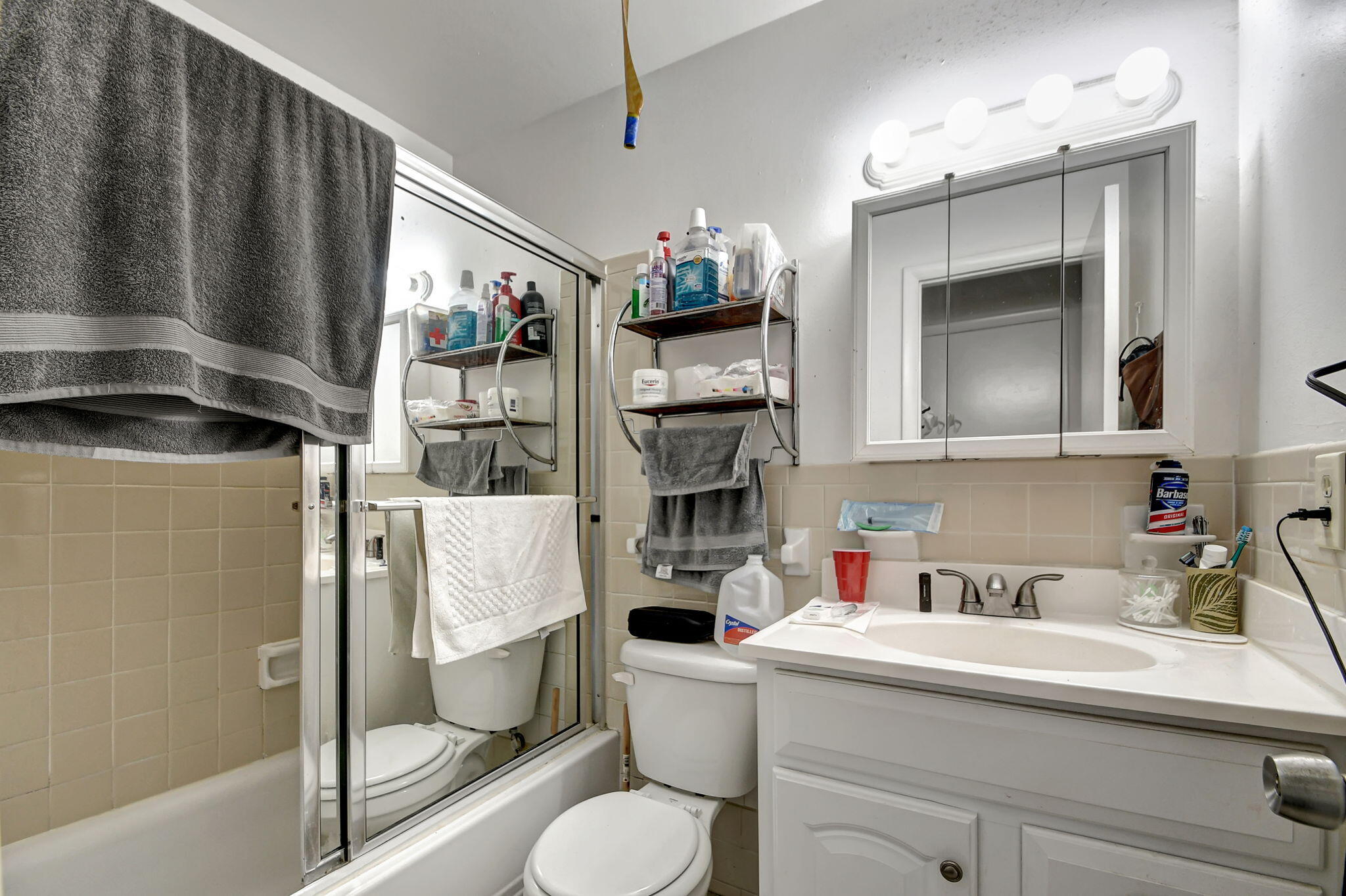 1853 Service Road North Palm Beach, FL 33408 - Photo 23 of 113 a bathroom with a sink a toilet and shower