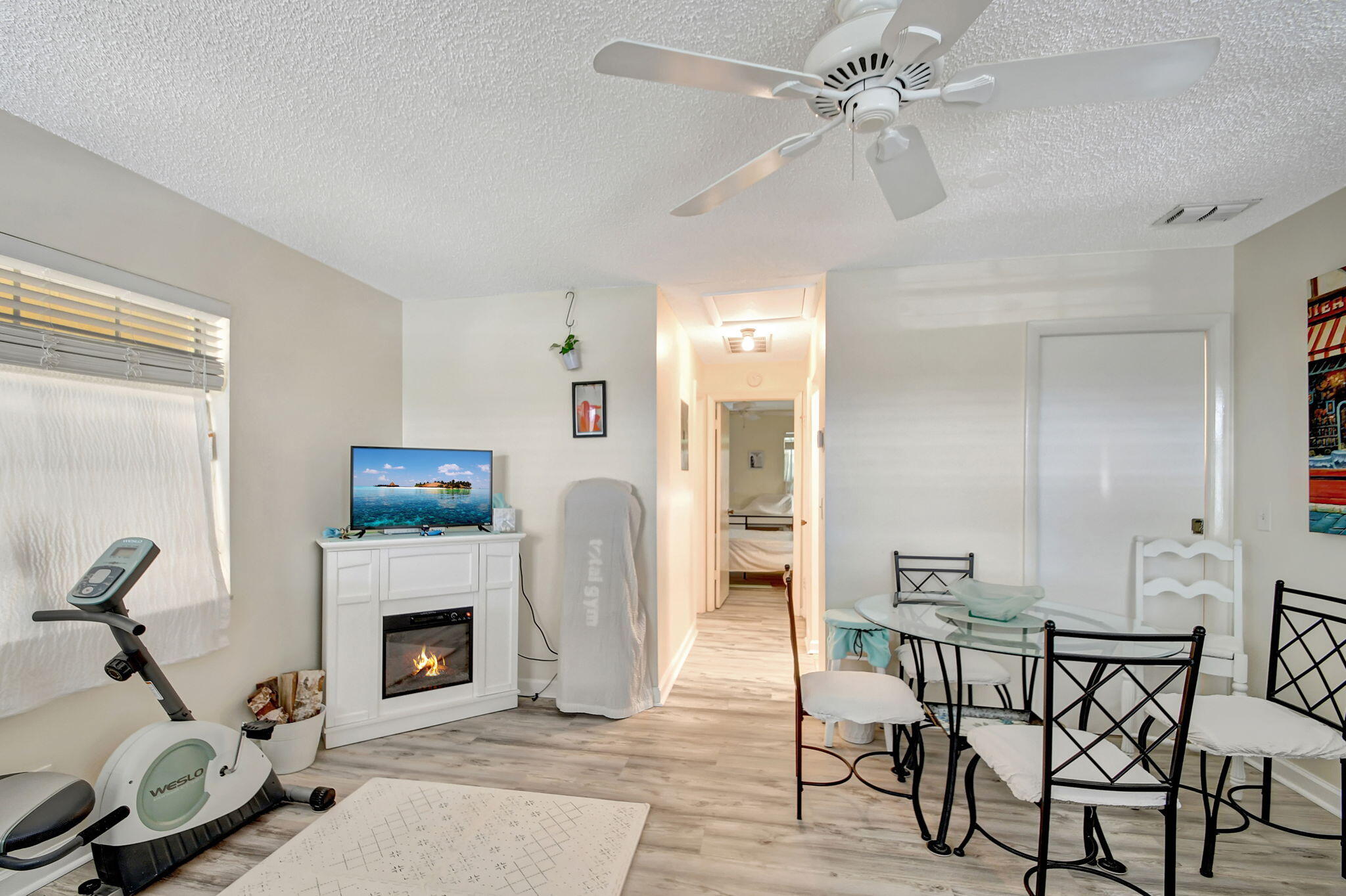 1853 Service Road North Palm Beach, FL 33408 - Photo 25 of 113 a living room with furniture a fireplace and a flat screen tv