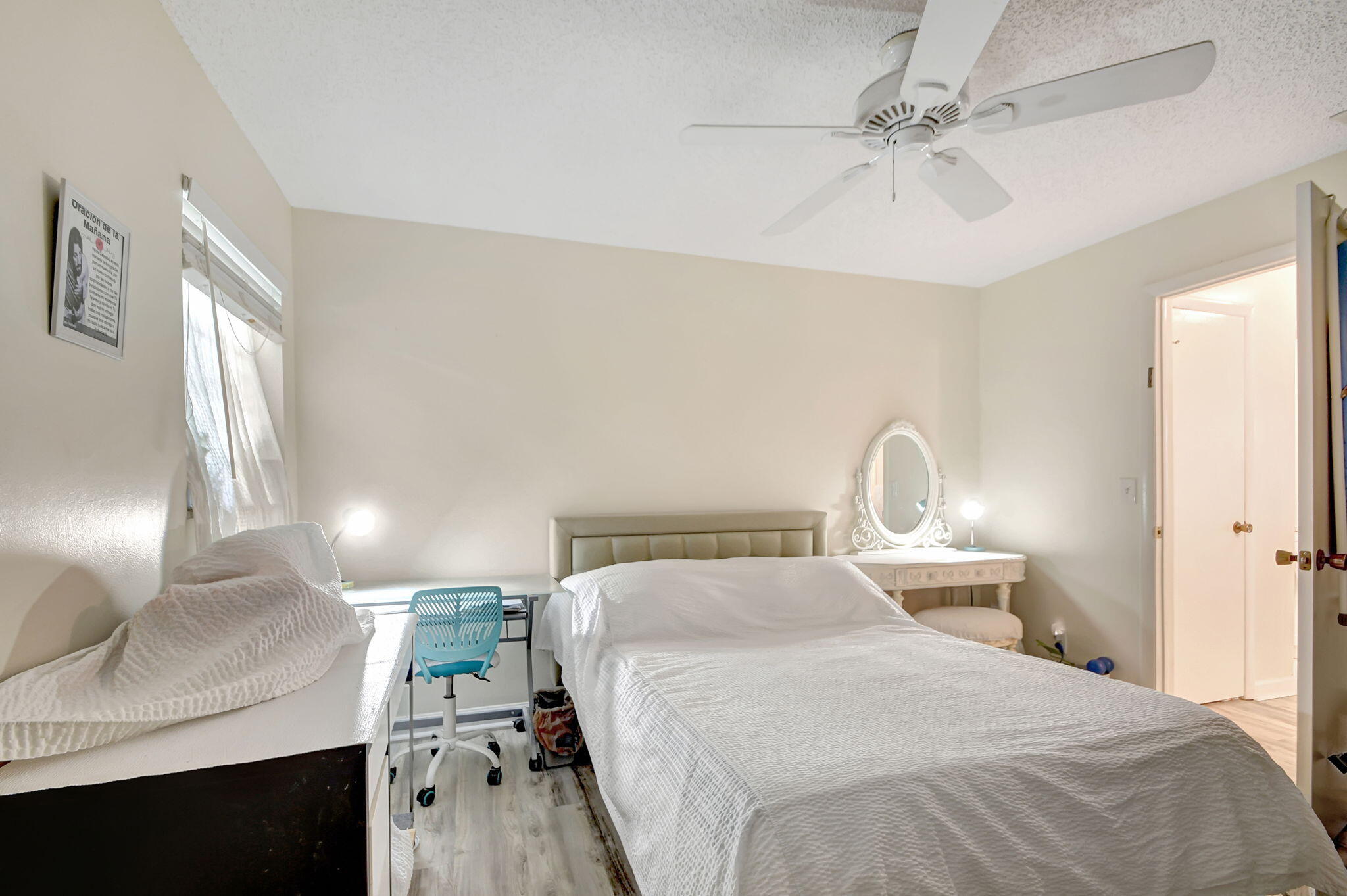 1853 Service Road North Palm Beach, FL 33408 - Photo 33 of 113 a bedroom with a bed and a chandelier