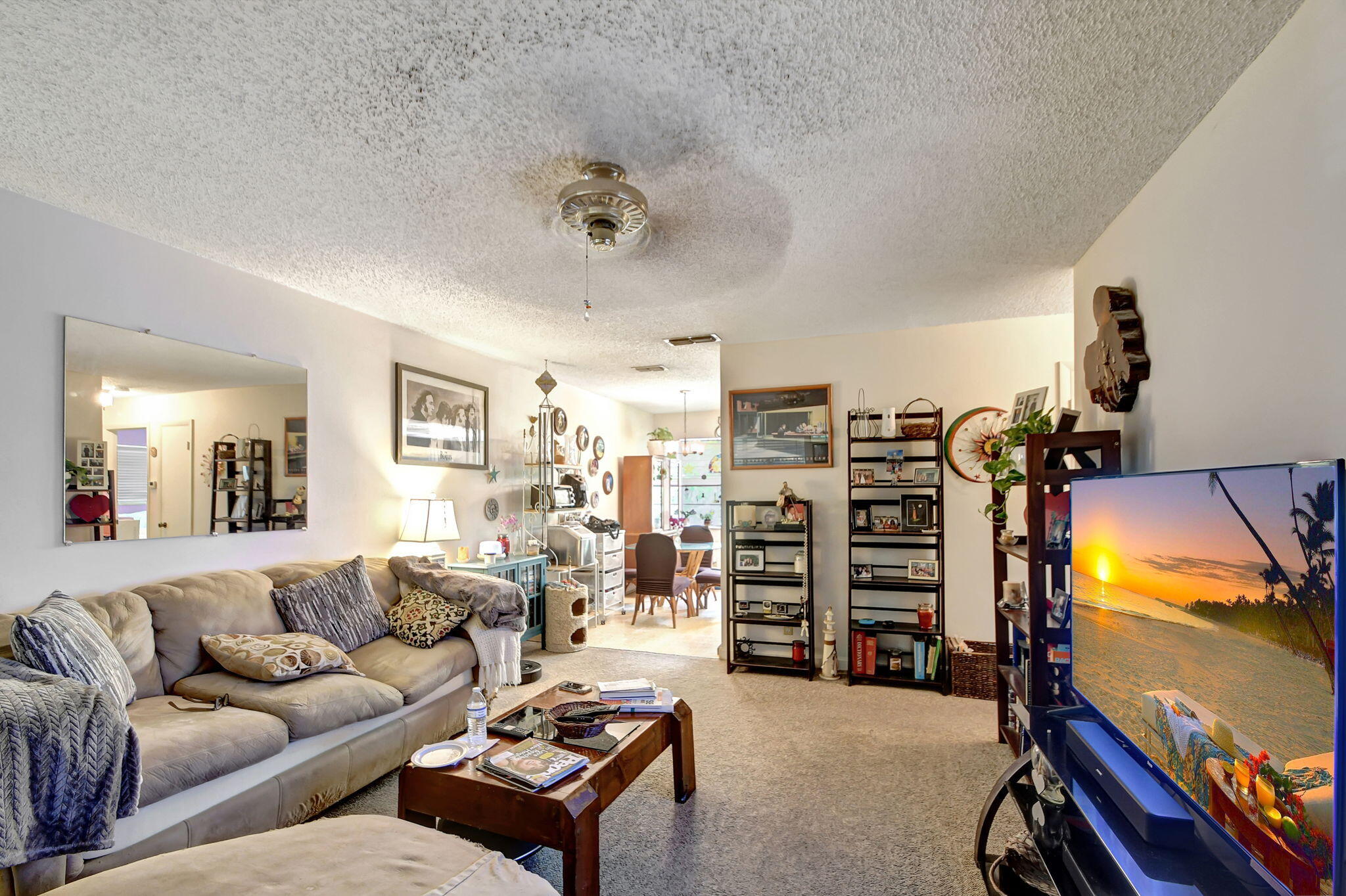 1853 Service Road North Palm Beach, FL 33408 - Photo 39 of 113 a living room with furniture a lamp and a flat screen tv