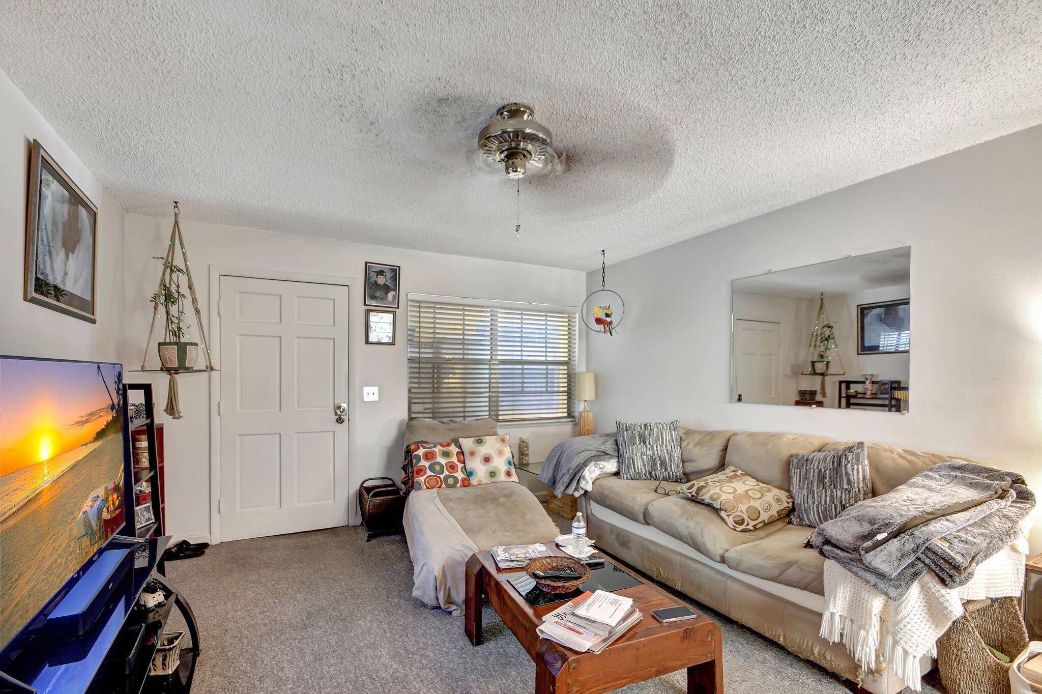 1853 Service Road North Palm Beach, FL 33408 - Photo 40 of 113 a living room with furniture a flat screen tv and a window