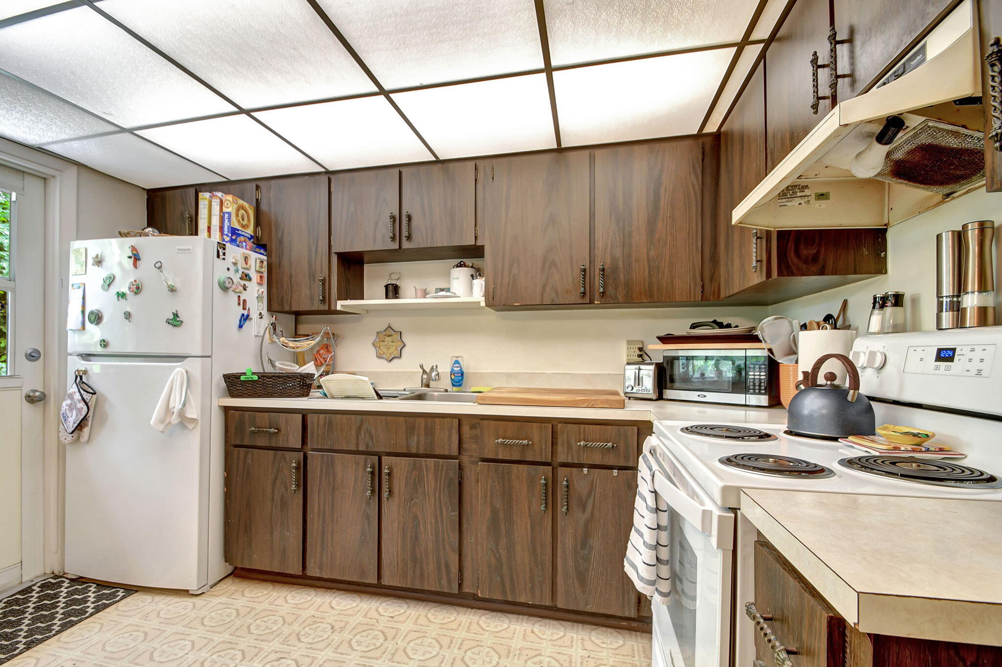 1853 Service Road North Palm Beach, FL 33408 - Photo 43 of 113 a kitchen with stainless steel appliances granite countertop a sink a stove a refrigerator and cabinets