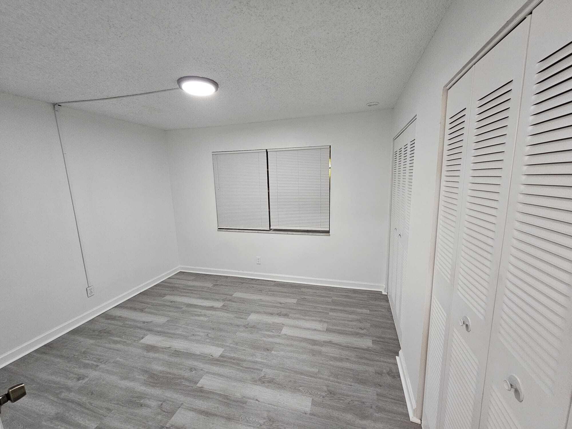 1853 Service Road North Palm Beach, FL 33408 - Photo 55 of 113 a view of an empty room with wooden floor
