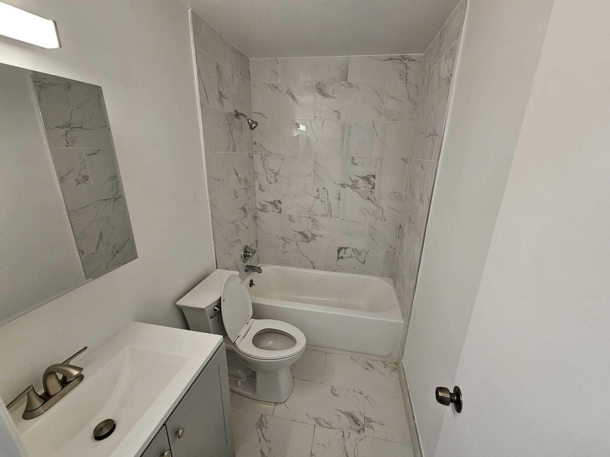 1853 Service Road North Palm Beach, FL 33408 - Photo 60 of 113 a bathroom with a sink a toilet and bathtub