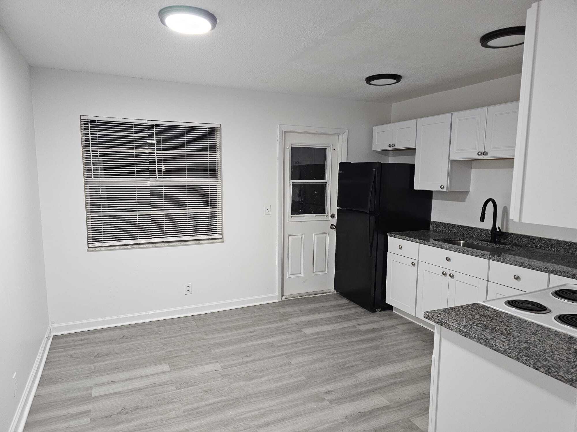 1853 Service Road North Palm Beach, FL 33408 - Photo 61 of 113 a kitchen with stainless steel appliances granite countertop a refrigerator and a stove top oven