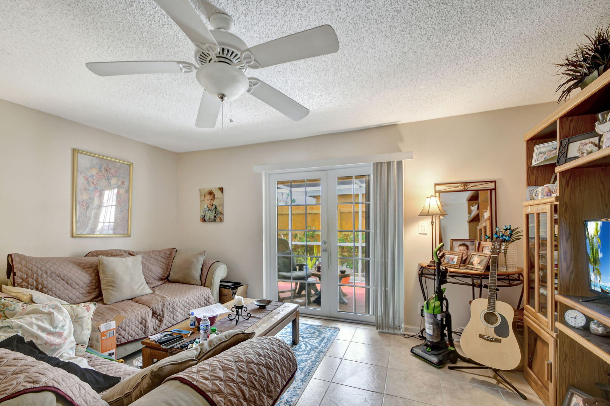 1853 Service Road North Palm Beach, FL 33408 - Photo 76 of 113 a living room with furniture a window and gym equipment