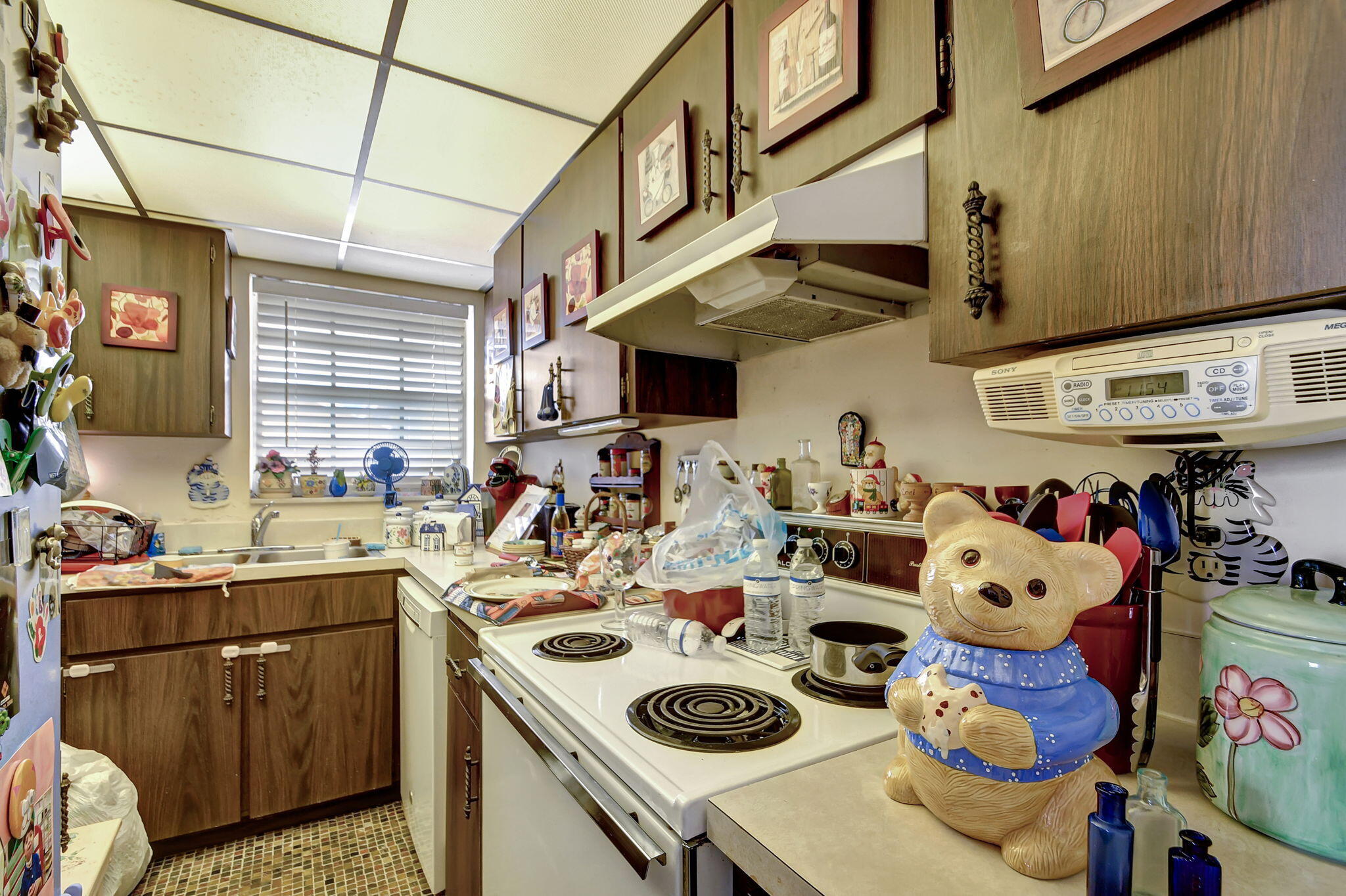 1853 Service Road North Palm Beach, FL 33408 - Photo 9 of 113 a kitchen with lots of clutter and cabinets
