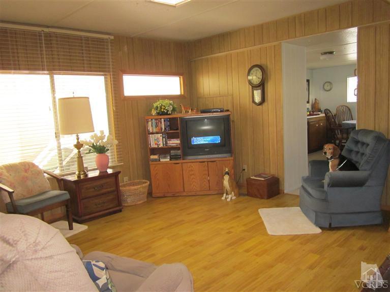 1225 South Rice Road, Unit 72 Ojai, CA 93023 - Photo 2 of 9 a bedroom with furniture and a flat screen tv
